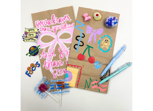 Decorated paper bags with highlighters, stickers, lollipops, erasers on top
