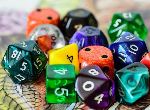 Multicolored, multi-sided dice on top of a game board.